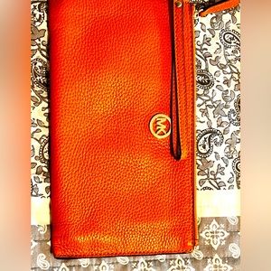 Michael Kors burnt orange wristlet